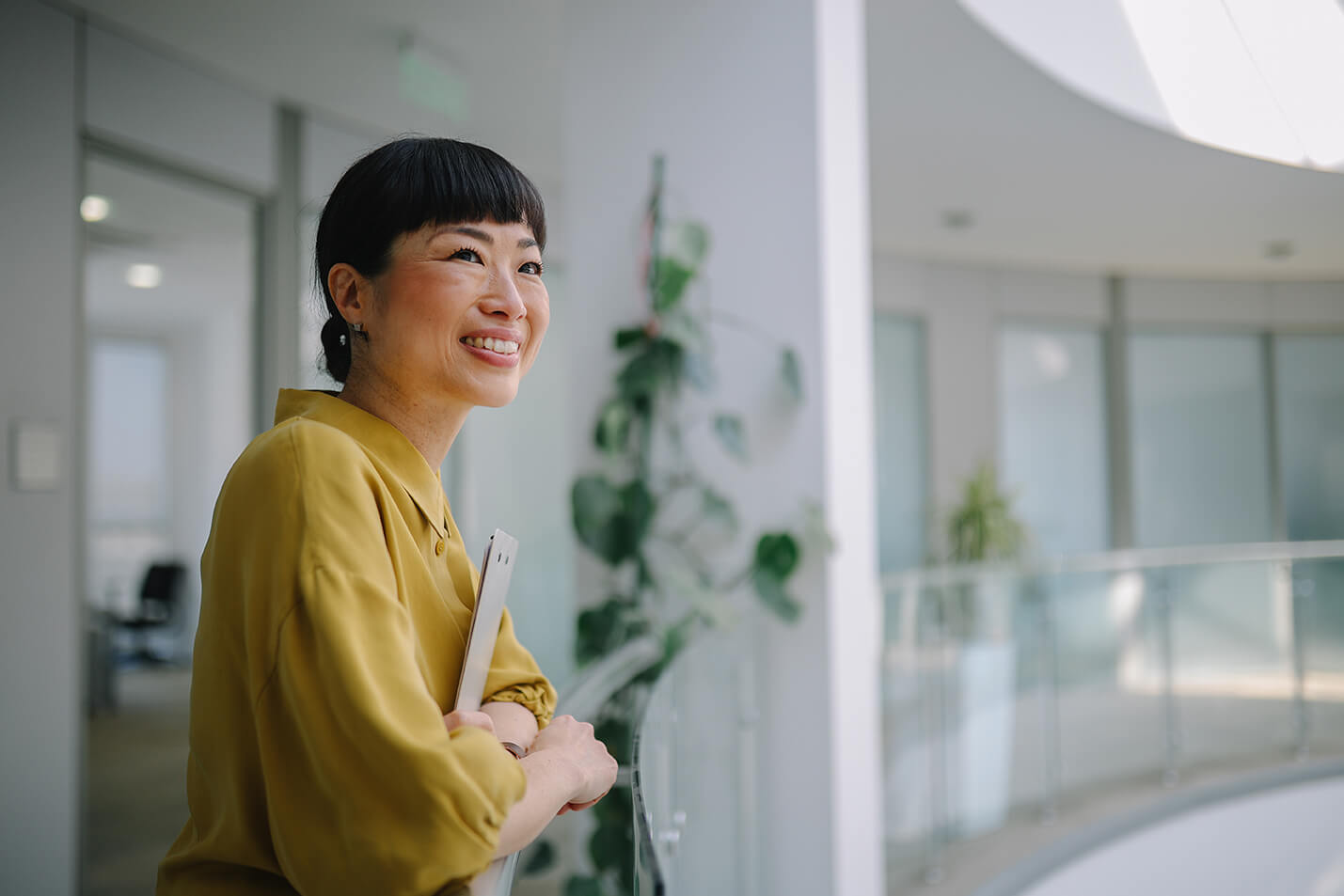 A woman in a corporate setting smiling