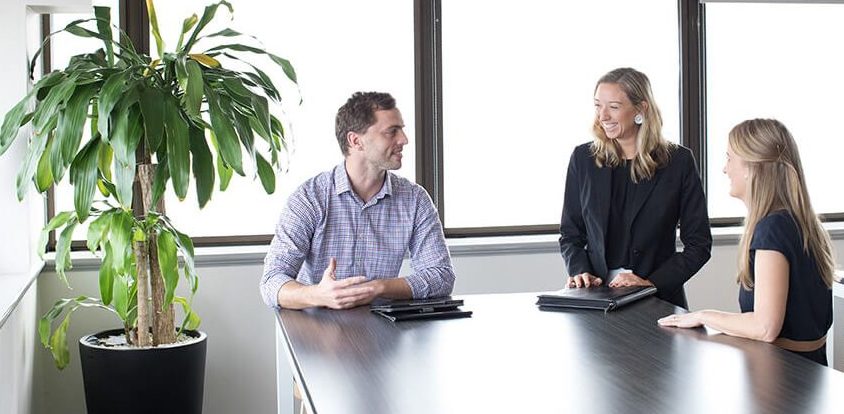 Group of people talking and smiling at a table