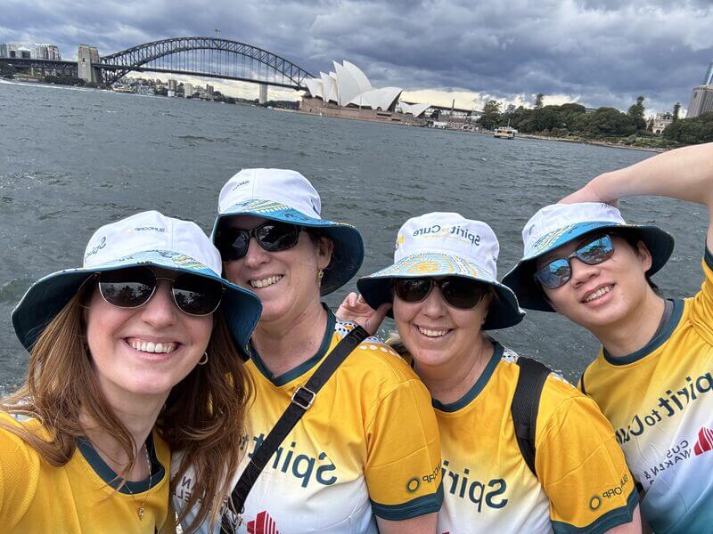 Participants smiling to camera with the Sydney Opera House in the background